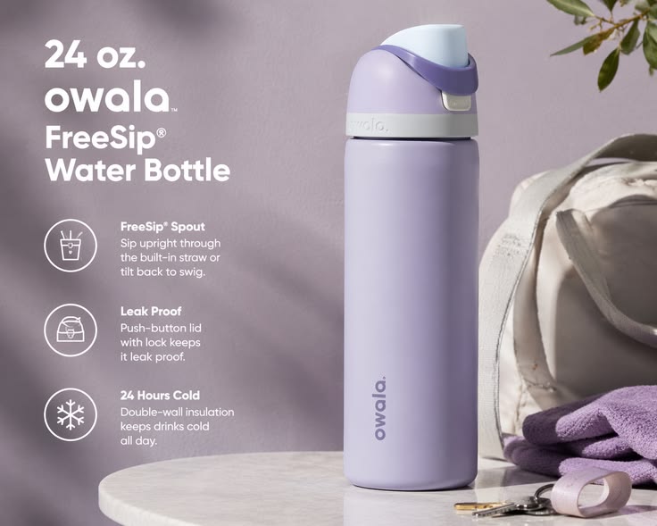 Owala 24 oz water bottle placed beside dumbbells and yoga mat in a gym setting for fitness hydration